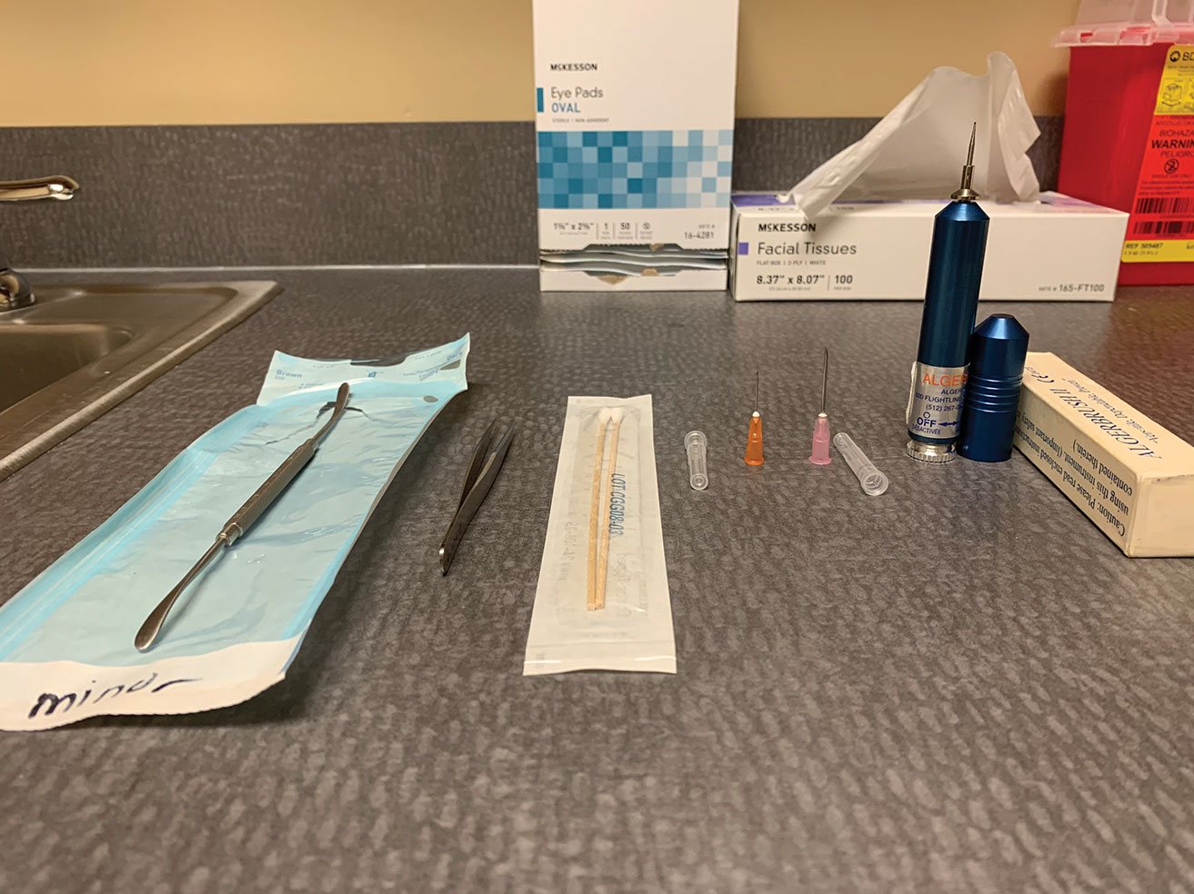 The foreign body removal toolkit includes a spud, jeweler’s forceps, cotton swabs, small-gauge needles and an Alger brush.