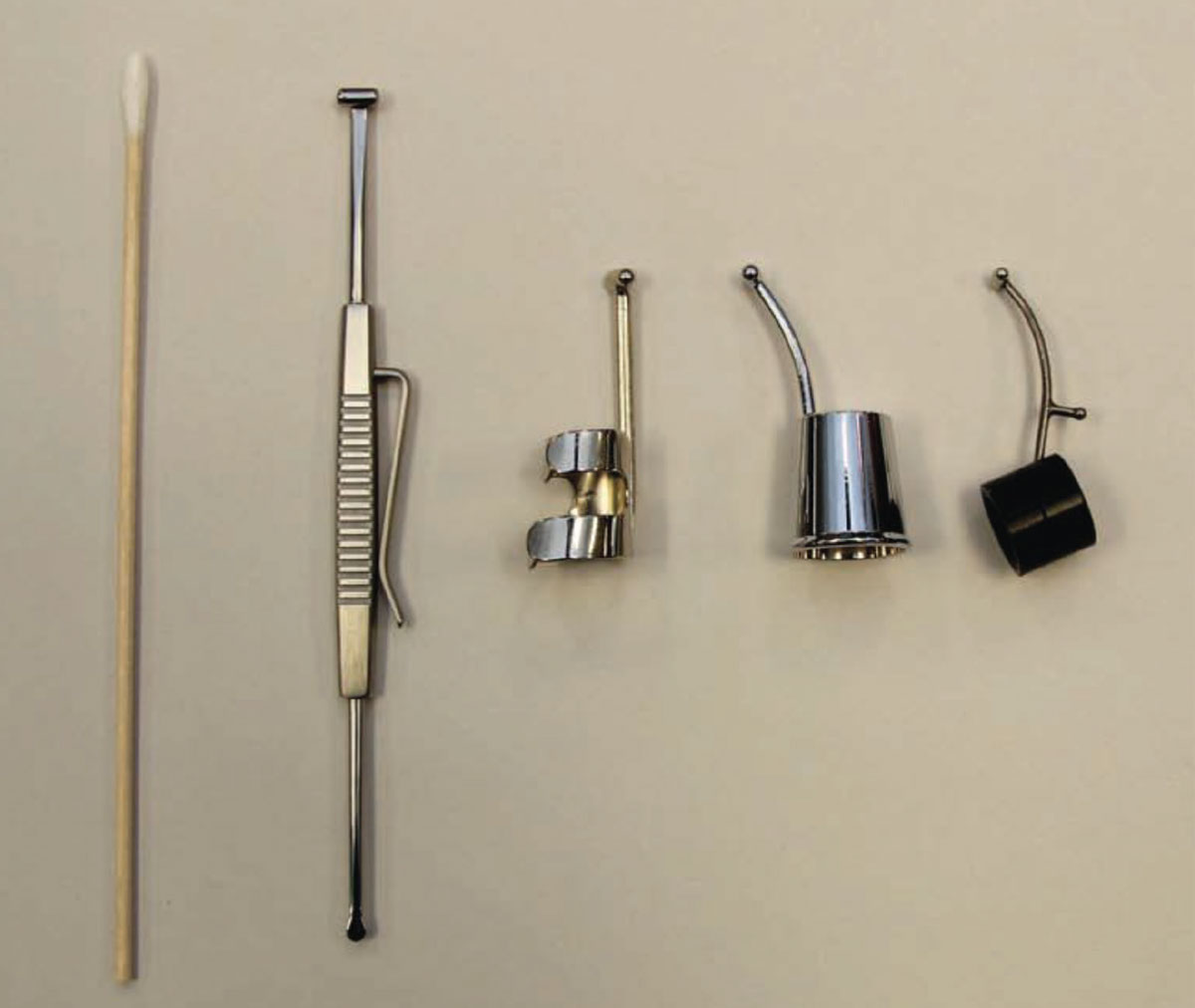 Fig. 5. Different types of scleral depressors, including a cotton-tipped applicator, a flat double-ended depressor and thimble depressors.